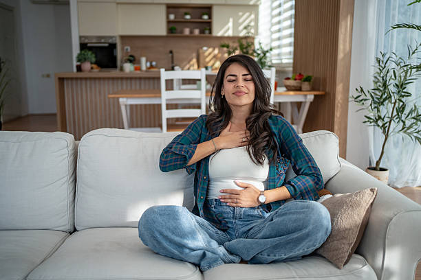 Person sitting quietly in a sunlit room practicing mindfulness